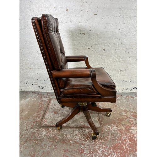 25 - A Bevan Funnell Reprodux brown leather and mahogany swivel office desk chair