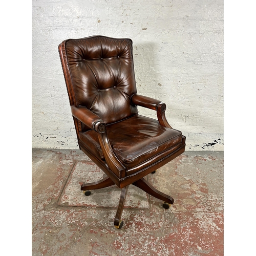 30 - A Bevan Funnell Reprodux brown leather and mahogany swivel office desk chair