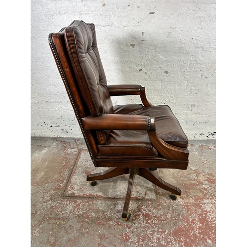 30 - A Bevan Funnell Reprodux brown leather and mahogany swivel office desk chair