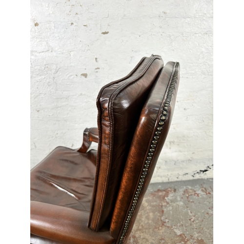 30 - A Bevan Funnell Reprodux brown leather and mahogany swivel office desk chair