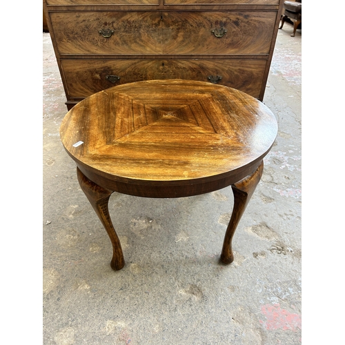 31 - A walnut circular coffee table on cabriole supports - approx. 46cm high x 60cm diameter