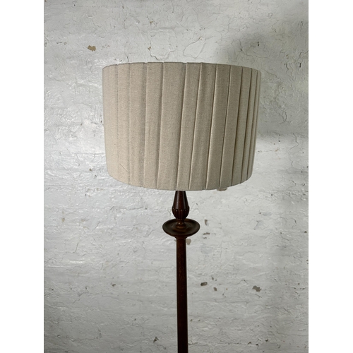 33 - A 19th century style mahogany standard lamp with circular base - approx. 166cm high