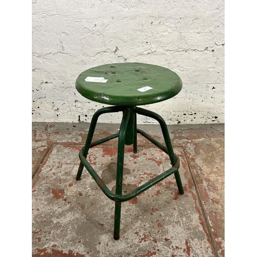 34 - A mid 20th century green painted metal industrial stool - approx. 50cm high x 32cm diameter