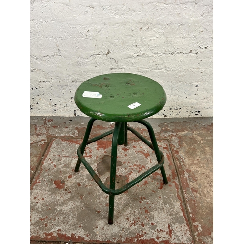 34 - A mid 20th century green painted metal industrial stool - approx. 50cm high x 32cm diameter