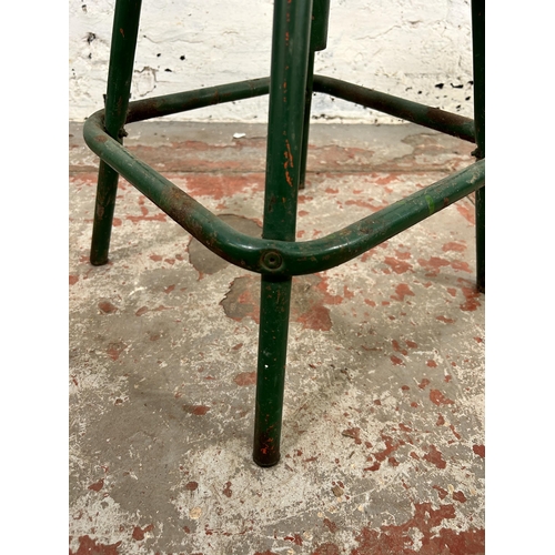 34 - A mid 20th century green painted metal industrial stool - approx. 50cm high x 32cm diameter