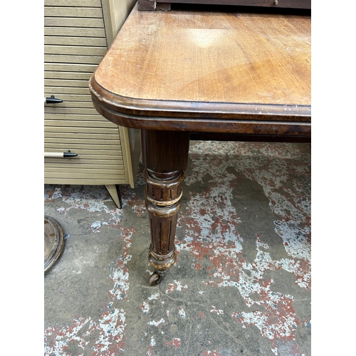 35 - A Victorian mahogany wind out dining table with extra leaf and winder - approx. 72cm high x 103cm wi... 