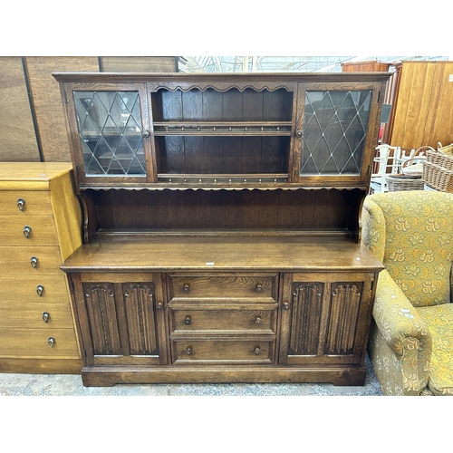 50 - A mid 20th century oak linenfold dresser - approx. 164cm high x 160cm wide x 48cm deep