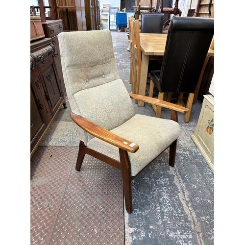 52 - A mid 20th century Parker Knoll PK1067-70 beech and fabric upholstered armchair