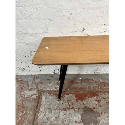 57 - A mid 20th century teak and ebonised rectangular coffee table