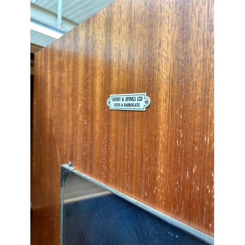 58 - A Denby & Spinks Ltd Leeds & Harrogate walnut dressing table and double wardrobe