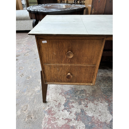 63 - A mid 20th century Meredew oak pedestal desk - approx. 71cm high x 122cm wide x 51cm deep