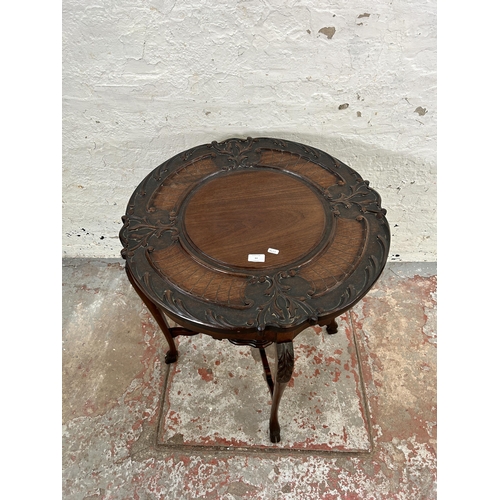 64 - A late Victorian carved mahogany two tier occasional table - approx. 73cm high x 68cm diameter