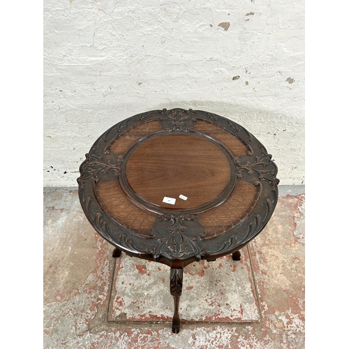 64 - A late Victorian carved mahogany two tier occasional table - approx. 73cm high x 68cm diameter