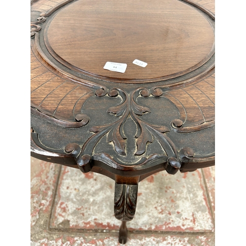 64 - A late Victorian carved mahogany two tier occasional table - approx. 73cm high x 68cm diameter