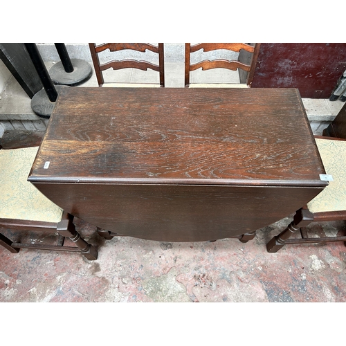 66 - A mid 20th century oak drop leaf gate leg dining table and four chairs