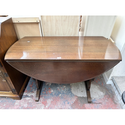 69 - An oak drop leaf oval dining table