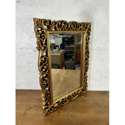 8 - A gilt framed bevelled edge wall mirror - approx. 82cm high x 60cm wide