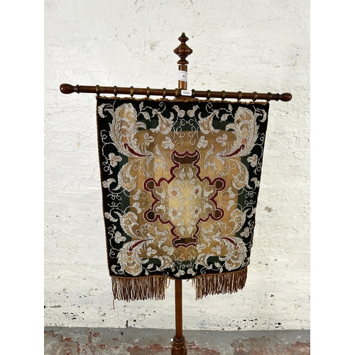 81 - A Victorian walnut tapestry and beadwork pole screen on tripod pedestal support  - approx. 146cm hig... 