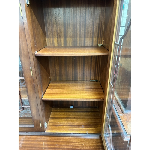 94 - A Regency style mahogany bookcase with three astral glazed doors - approx. 177cm high x 132cm wide 4... 