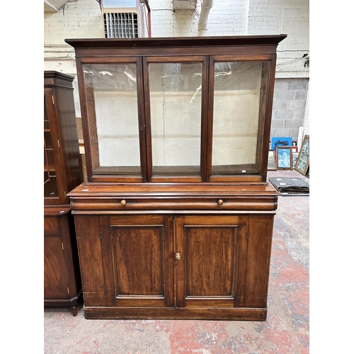 95 - A Victorian mahogany bookcase with three upper glazed doors - approx. 185cm high x 141cm wide x 46cm... 