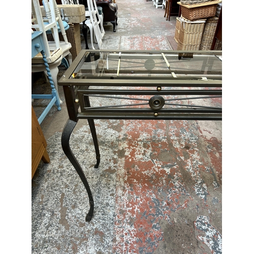 97 - A wrought metal and bevelled glass console table  - approx. 76cm high x 110cm wide x 33cm deep