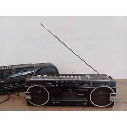 710 - Two portable stereo four-band radio cassette players, one Panasonic RX-FT570 and one Sharp QT-27E