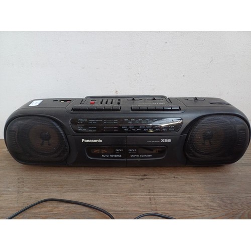 710 - Two portable stereo four-band radio cassette players, one Panasonic RX-FT570 and one Sharp QT-27E