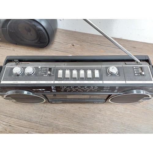 710 - Two portable stereo four-band radio cassette players, one Panasonic RX-FT570 and one Sharp QT-27E