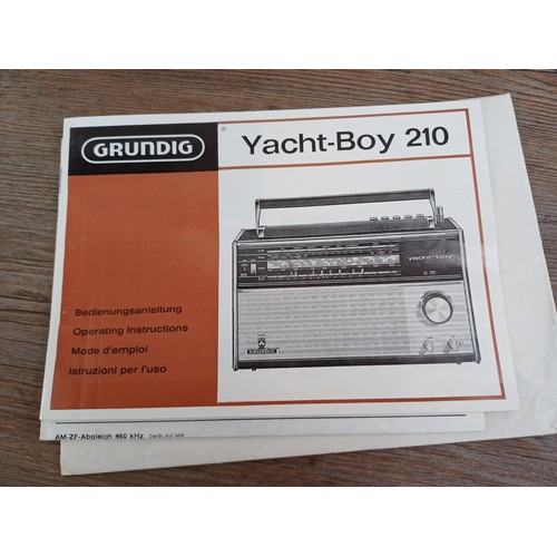 711 - Two vintage Grundig four-band portable radios, one Elite-Boy 600 and one Yacht-Boy 210 with instruct... 