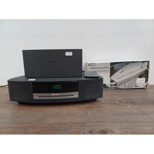 712 - A Bose AWRCC5 wave music system with DAB module and remote control together with a boxed paper shred... 