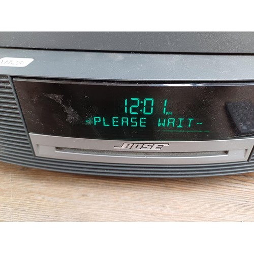 712 - A Bose AWRCC5 wave music system with DAB module and remote control together with a boxed paper shred... 