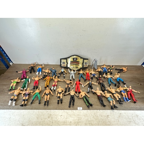 476 - A large collection of WWE action figurines together with WWE Cruiserweight Champion belt