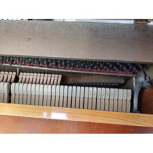 780 - A walnut Bentley upright piano with height adjustable stool and sheet music