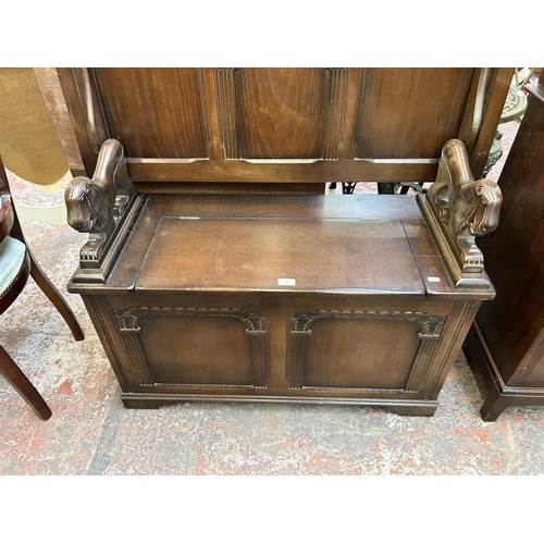 190 - A carved oak monk’s bench - approx. 105cm high x 107cm wide x 42cm deep