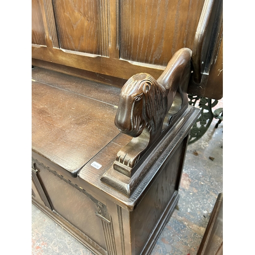 190 - A carved oak monk’s bench - approx. 105cm high x 107cm wide x 42cm deep