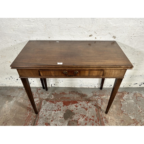 195 - A George III mahogany fold-over tea table - approx. 72cm high x 91cm wide x 89cm long when extended