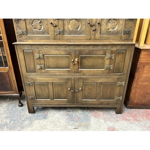 200 - A 17th century style carved oak court cupboard - approx. 152cm high x 147cm wide x 42cm deep