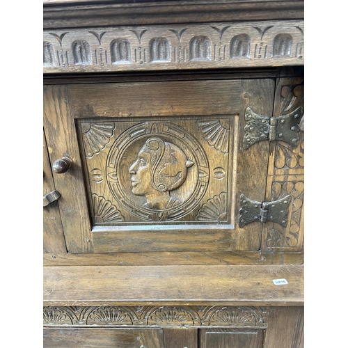 200 - A 17th century style carved oak court cupboard - approx. 152cm high x 147cm wide x 42cm deep