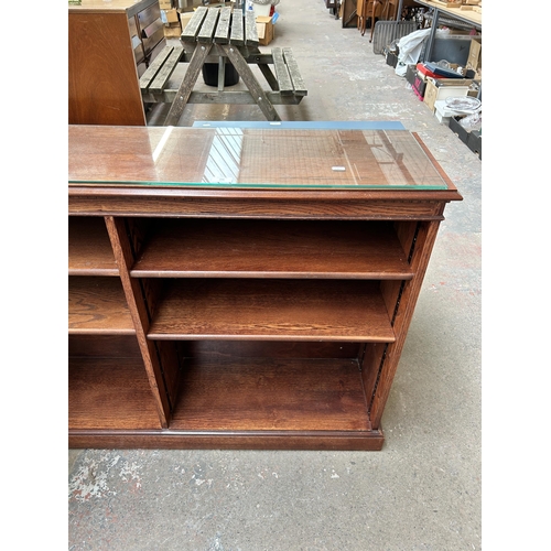 206 - An oak six tier freestanding open bookcase - approx. 93cm high x 136cm wide x 31cm deep