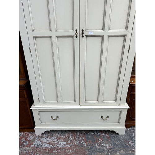 211 - A modern white painted double wardrobe - approx. 201cm high x 128cm wide x 62cm deep