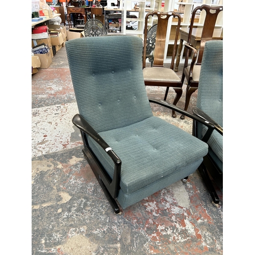 225 - A pair of mid 20th century Parker Knoll fabric upholstered and ebonised reclining armchairs