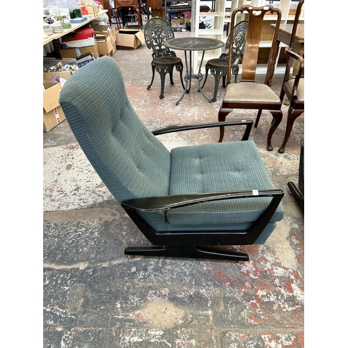 225 - A pair of mid 20th century Parker Knoll fabric upholstered and ebonised reclining armchairs