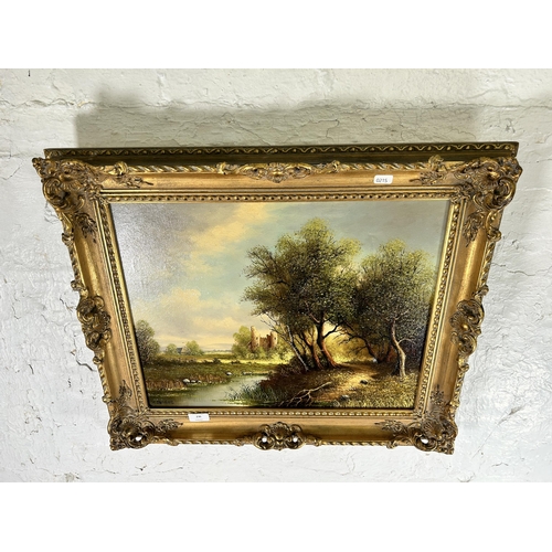 236 - A gilt framed H. Sanders oil on canvas of a landscape scene - approx. 55cm high x 65cm wide