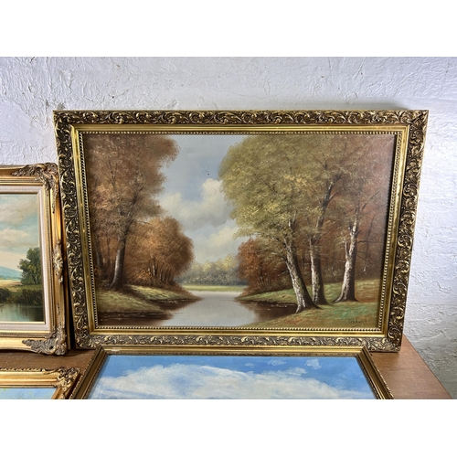 251 - Four gilt framed oil paintings - largest approx. 71cm high x 102cm wide