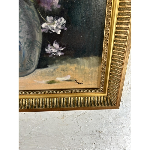 259 - A gilt framed floral still life oil on canvas, signed lower right - approx. 74cm high x 63cm wide