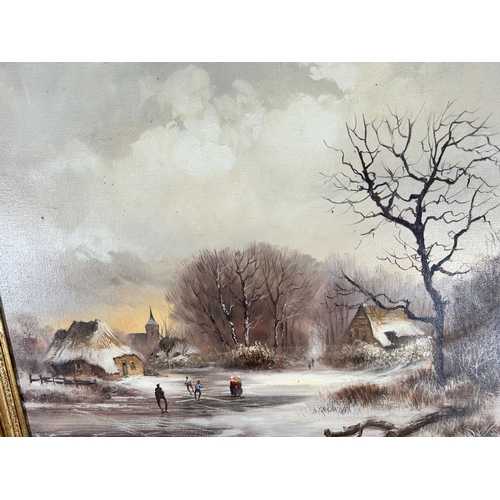 282 - A gilt framed oil on canvas of a winter landscape scene, signed lower right - approx. 65cm high x 75... 