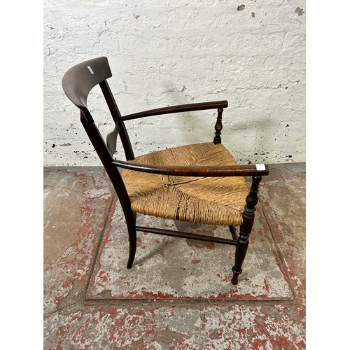 183 - A late 19th/early 20th century beech and rush seated armchair