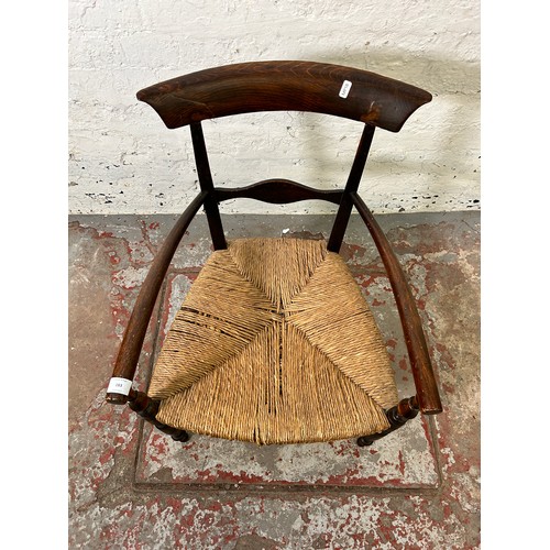 183 - A late 19th/early 20th century beech and rush seated armchair