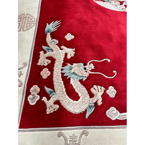 129 - A Chinese dragon pattern rug - approx. 280cm x 183cm