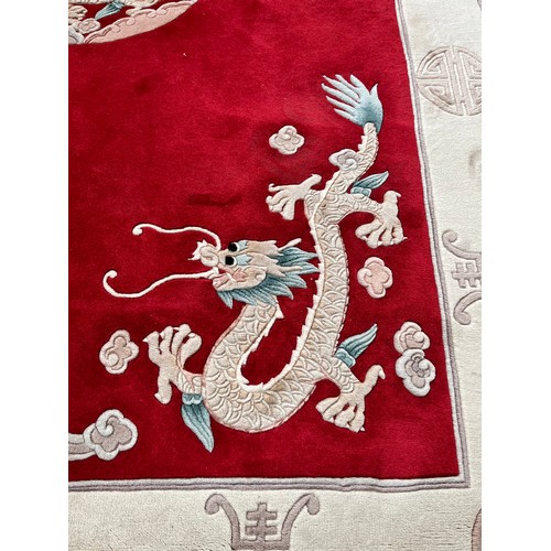 129 - A Chinese dragon pattern rug - approx. 280cm x 183cm